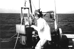 Photograph showing scientist collecting samples from the bottom of the Mississippi Sound